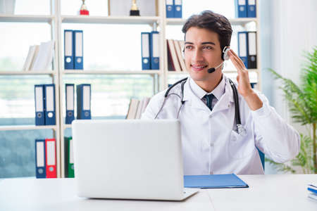Young male doctor in telehealth conceptの写真素材