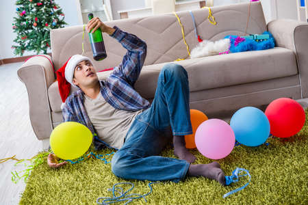 Man having hangover after christmas partyの写真素材