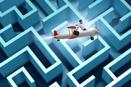 Businessman escaping from maze on airplaneの写真素材