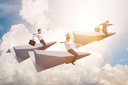 Businessman flying on paper plane in business conceptの写真素材