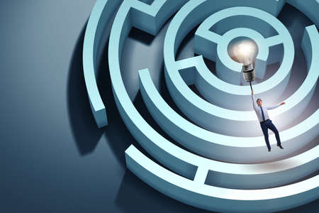 Businessman escaping from maze on balloonの写真素材