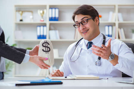 Young doctor in medical insurance fraud conceptの写真素材