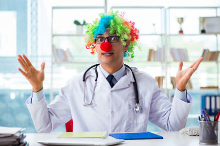 Funny pediatrician with clown wig in the hospital clinicの写真素材