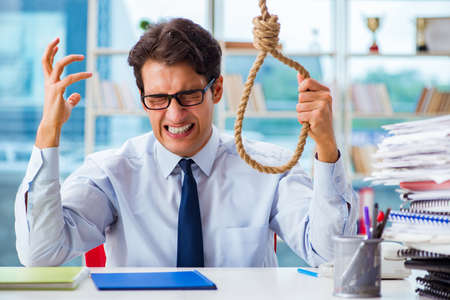 Concept of overworked businessman holding onto nooseの写真素材