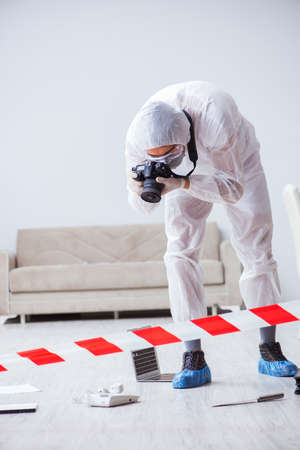 Forensic expert at crime scene doing investigationの写真素材