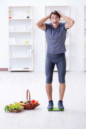 Man promoting the benefits of healthy eating and doing sportsの写真素材