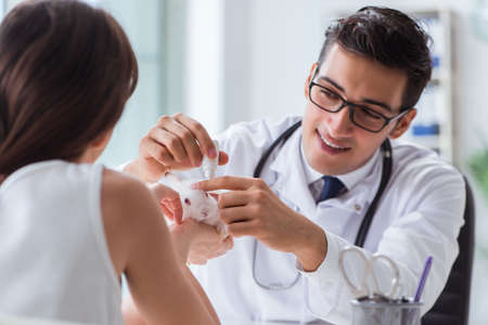 Woman with pet rabbit visiting vet doctorの写真素材