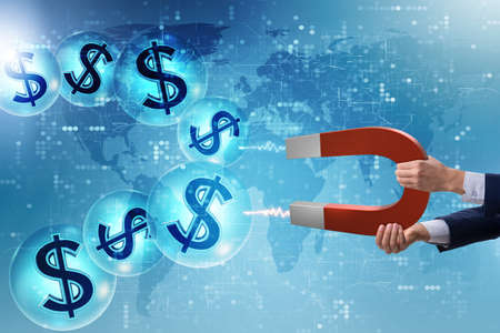 Businessman catching dollars on horseshoe magnetの写真素材