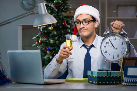Businessman working late on christmas day in officeの写真素材