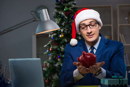 Businessman working late on christmas day in officeの写真素材