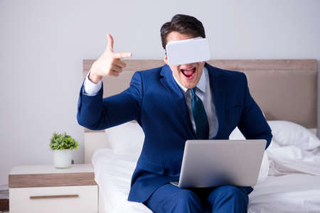 Businessman wearing a virtual reality headset in the bedroom