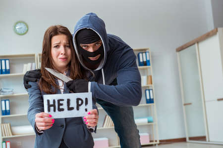 Criminal taking businesswoman as hostage in office