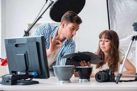 Young photographer working in photo studio