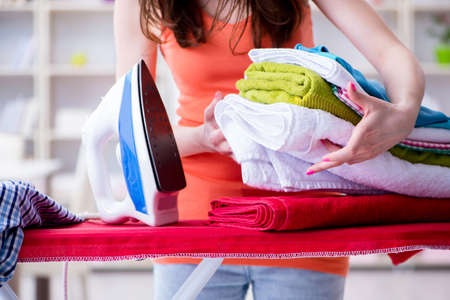 Woman wife doing ironing at homeの写真素材