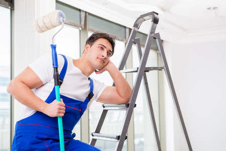Painter repairman working at construction siteの写真素材