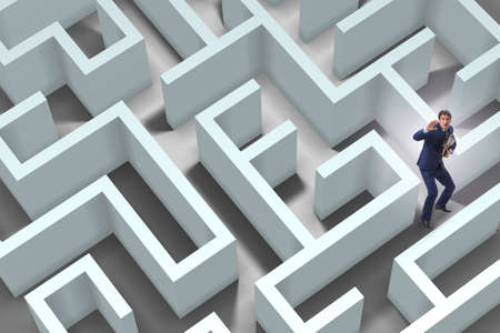 Businessman is trying to escape from maze labyrinthの写真素材