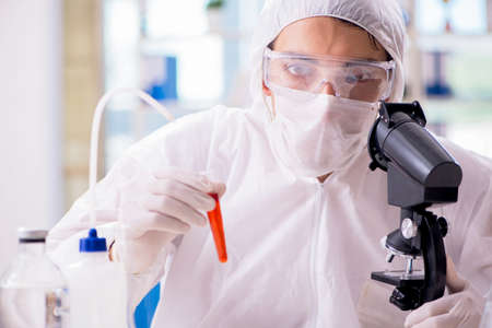 Chemist working in the laboratory with hazardous chemicals