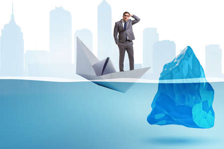 Economic crisis concept with businessman in sinking paper boatの写真素材