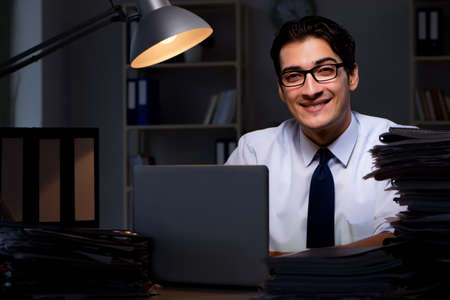 Young businessman working overtime late in office