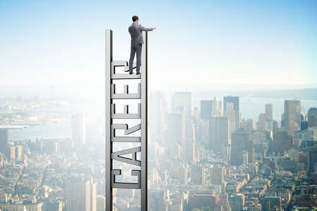Businessman in career ladder conceptの写真素材