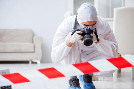 Forensic expert at crime scene doing investigationの写真素材