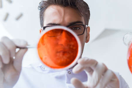 Chemist working in the laboratory with hazardous chemicals