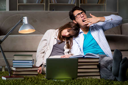 Two students studying late preparing for examsの写真素材