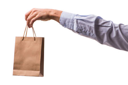 Hand holding shopping bags with christmas shopping on white back