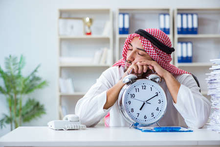 Arab businessman working in the office doing paperwork with a piの写真素材