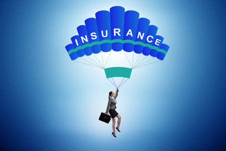 Businesswoman in insurance concept on parachuteの写真素材