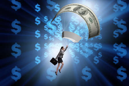 Businesswoman in golden parachute conceptの写真素材