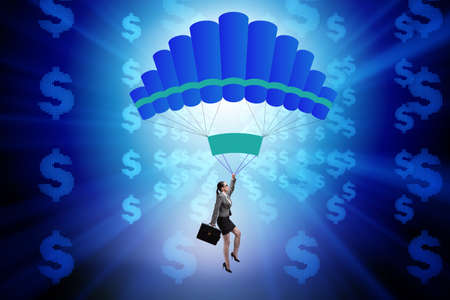 Businesswoman in golden parachute conceptの写真素材