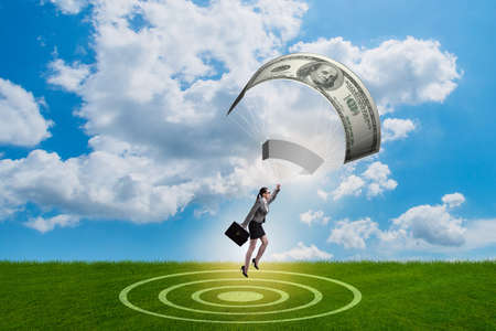 Businesswoman in golden parachute conceptの写真素材