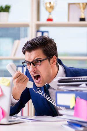 Businessman with reminder notes in multitasking conceptの写真素材