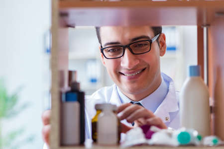 Doctor at farmacy retail shop looking for medicinesの写真素材
