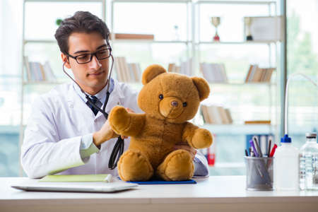 Pediatrician with toy sitting in the officeの写真素材
