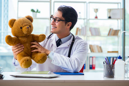 Pediatrician with toy sitting in the officeの写真素材