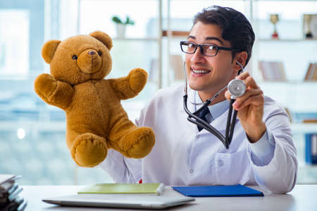 Pediatrician with toy sitting in the officeの写真素材