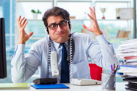 Unhappy angry call center worker frustrated with workloadの写真素材