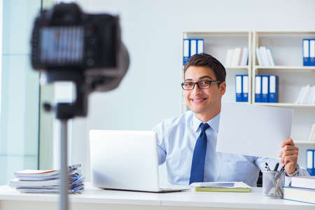 Business blogger doing webcast for his subscribersの写真素材