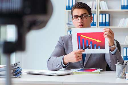 Business blogger doing webcast for his subscribersの写真素材