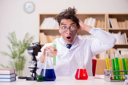 Mad crazy scientist doctor doing experiments in a laboratoryの写真素材