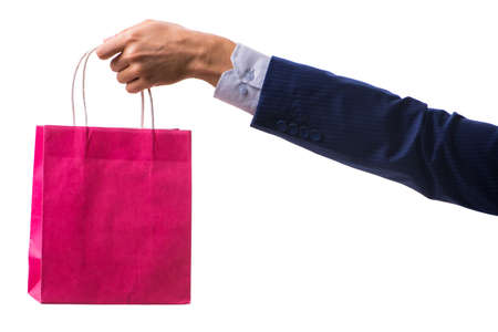 Hand holding shopping bags with christmas shopping on white backの写真素材