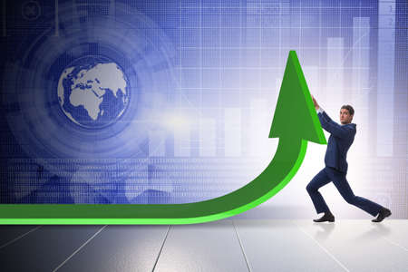 Businessman supporting growtn in economy on chart graphの写真素材