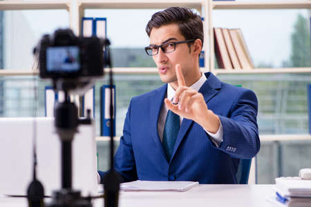 Businessman recording a video for vlogの写真素材