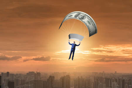 Businessman in golden parachute conceptの写真素材
