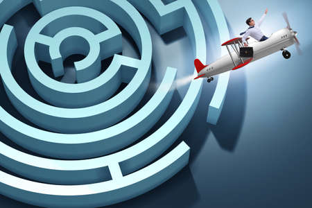 Businessman escaping from maze on airplaneの写真素材