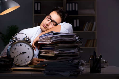 Young businessman working overtime late in office
