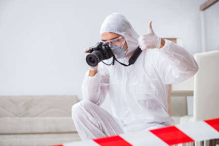Forensic expert at crime scene doing investigationの写真素材