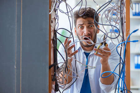 Electrician trying to untangle wires in repair concept